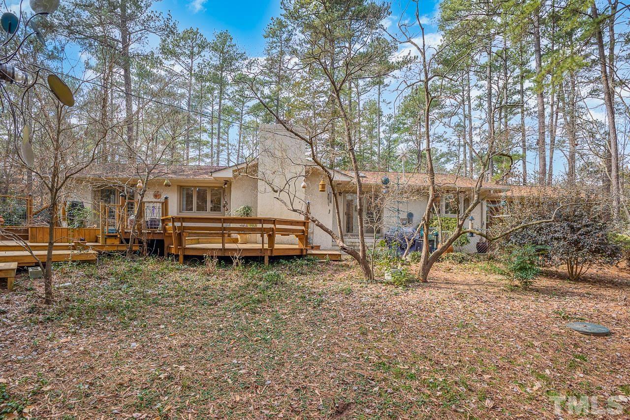 9006 Honeycutt Road Raleigh, NC 27615 - Photo 39 of 54 a backyard of a house with barbeque oven table and chairs