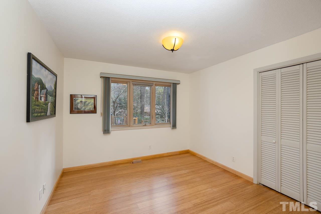 9006 Honeycutt Road Raleigh, NC 27615 - Photo 48 of 54 a view of an empty room with wooden floor and a window