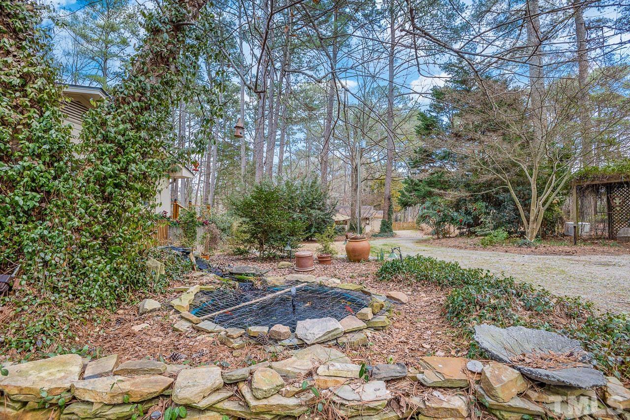 9006 Honeycutt Road Raleigh, NC 27615 - Photo 8 of 54 a backyard of a house with lots of green space