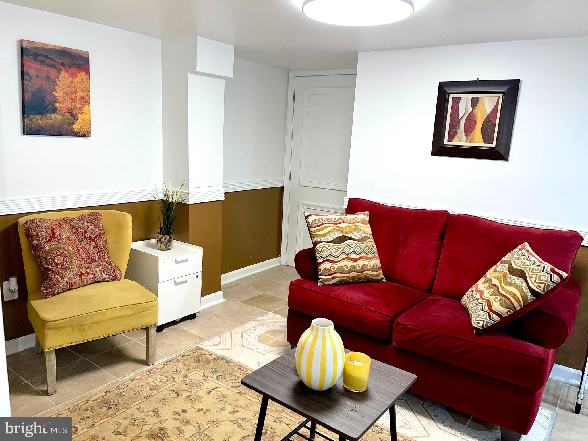 6906 Parkwood Street, Unit C Hyattsville, MD 20784 - Photo 3 of 9 a living room with furniture and a couch