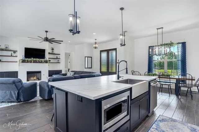 a view of living room kitchen island furniture and fireplace