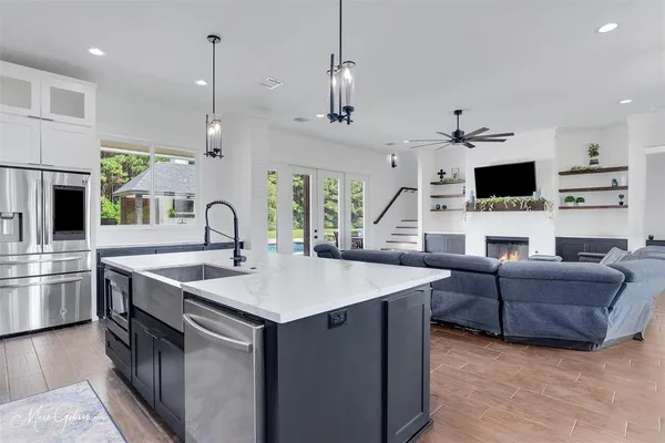 a view of living room kitchen island furniture and fireplace