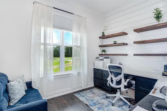 a view of workspace with wooden floor windows