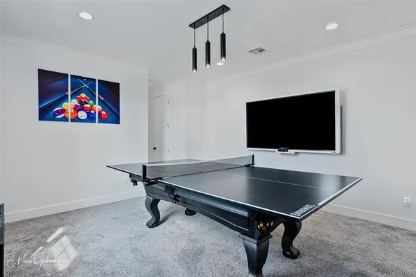 a room with pool table and windows