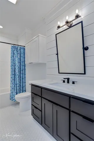 a bathroom with a sink double vanity and mirror