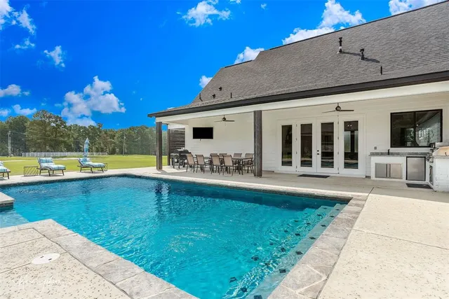 a view of a swimming pool with a patio