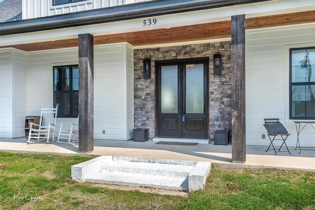 a view of front door of house with yard