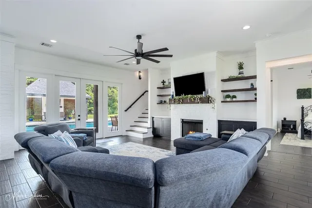 a living room with fireplace furniture and a flat screen tv