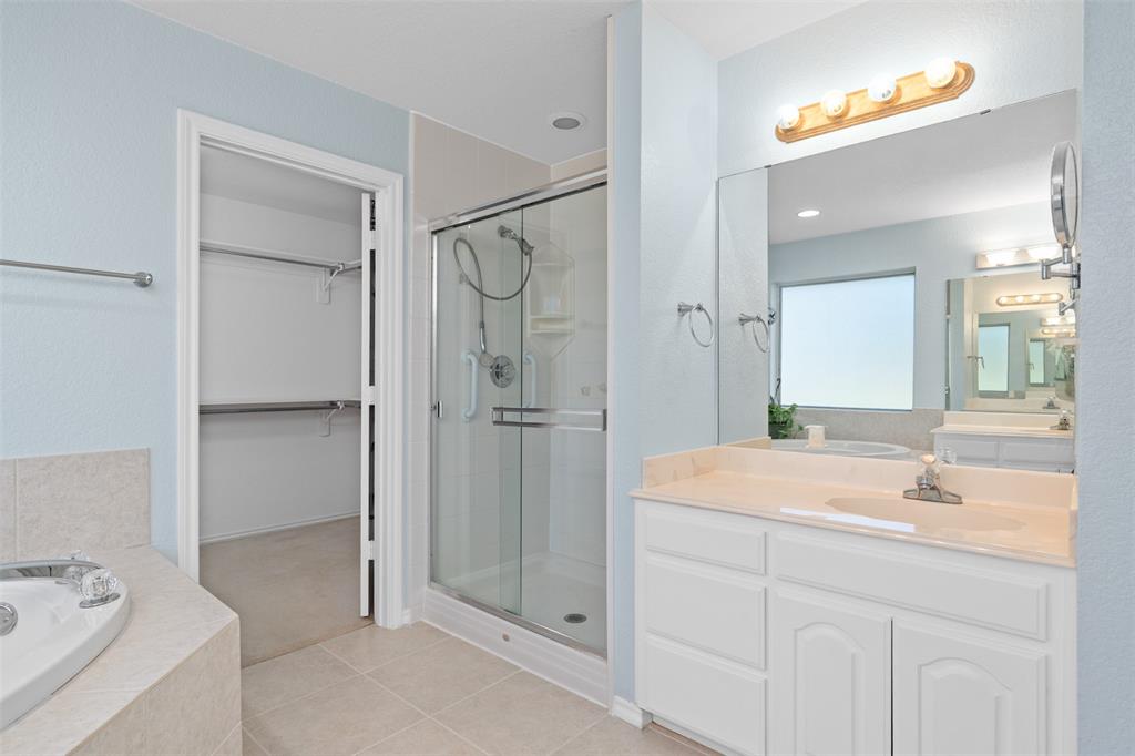 11306 Jennifer Circle Sanger, TX 76266 - Photo 13 of 24 a bathroom with a tub sink and mirror