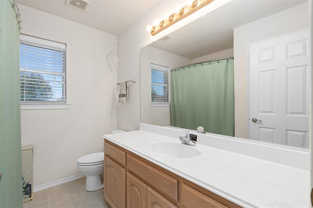 11306 Jennifer Circle Sanger, TX 76266 - Photo 14 of 24 a bathroom with a sink a toilet and shower