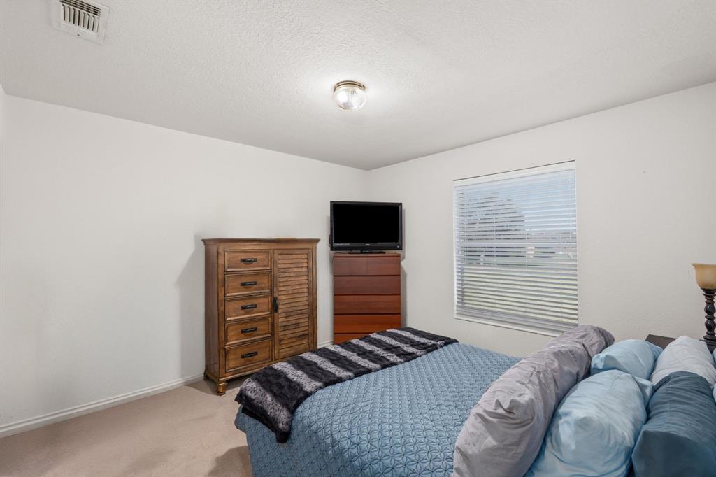 11306 Jennifer Circle Sanger, TX 76266 - Photo 16 of 24 a bedroom with a bed and a television