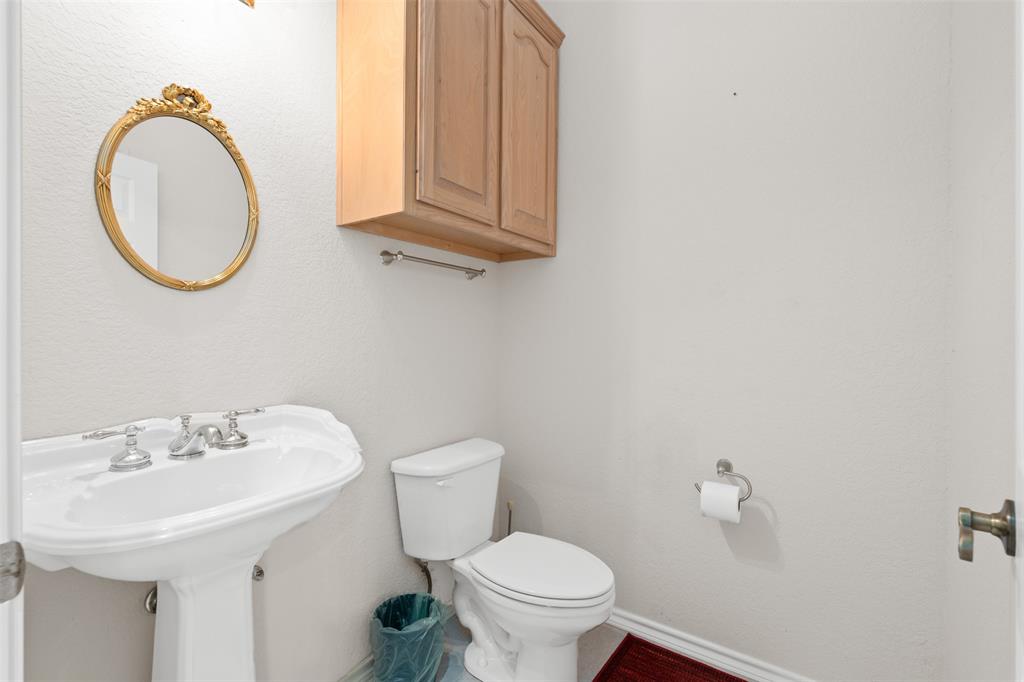 11306 Jennifer Circle Sanger, TX 76266 - Photo 18 of 24 a bathroom with a sink a toilet and a mirror
