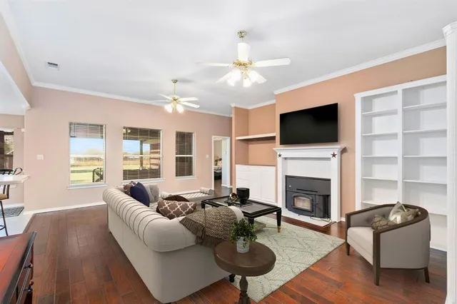 a living room with furniture a fireplace and a flat screen tv
