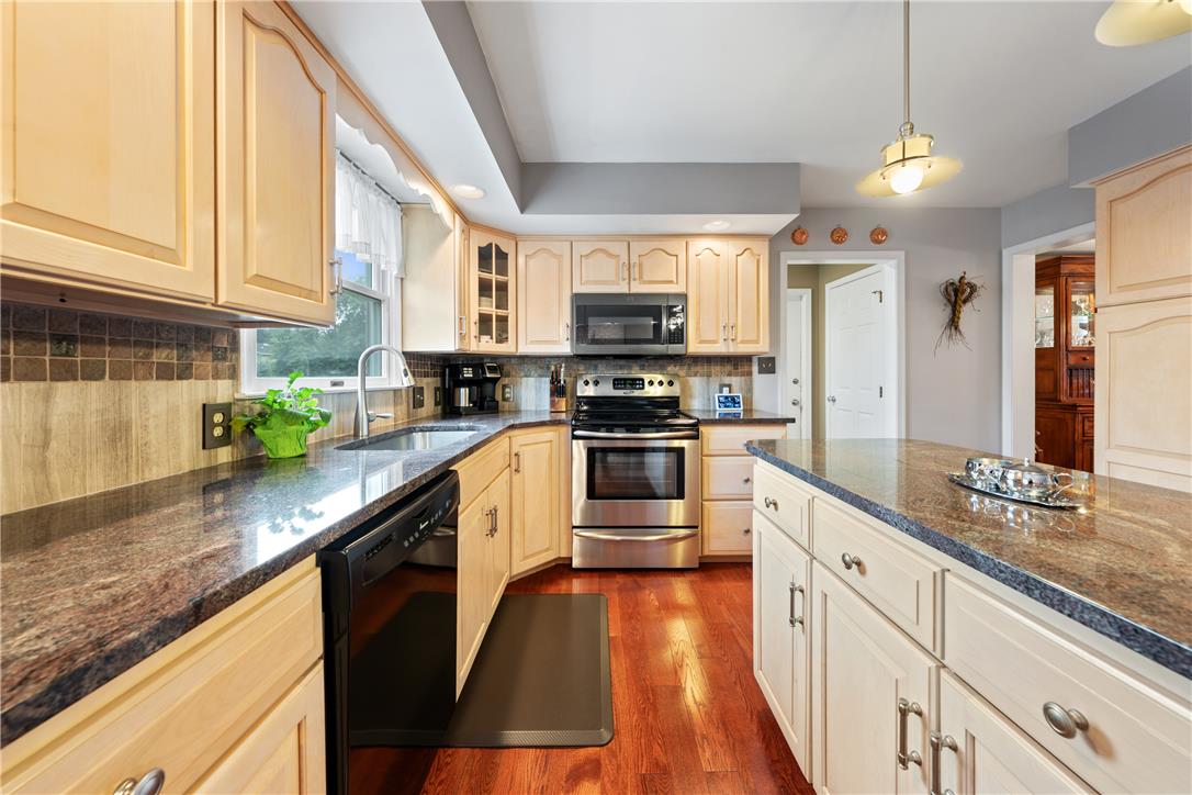 4568 Greenfield Road Bethlehem, PA 18017 - Photo 14 of 59 A well-appointed kitchen features rich hardwood flooring and sleek granite countertops, ideal for culinary creations.