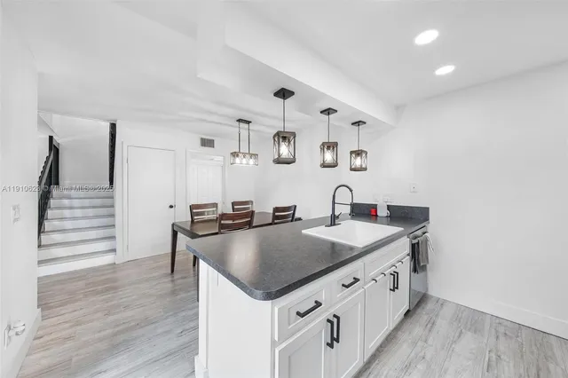 a kitchen with stainless steel appliances granite countertop a sink and stove