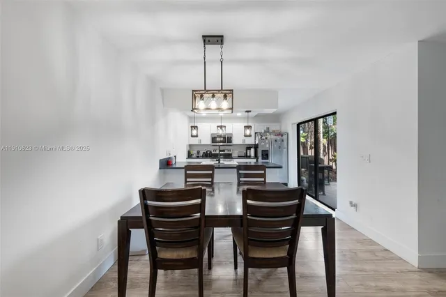 a view of a dining room with furniture and chandelier
