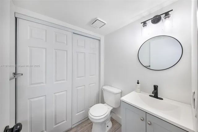 a bathroom with a sink a toilet and a mirror