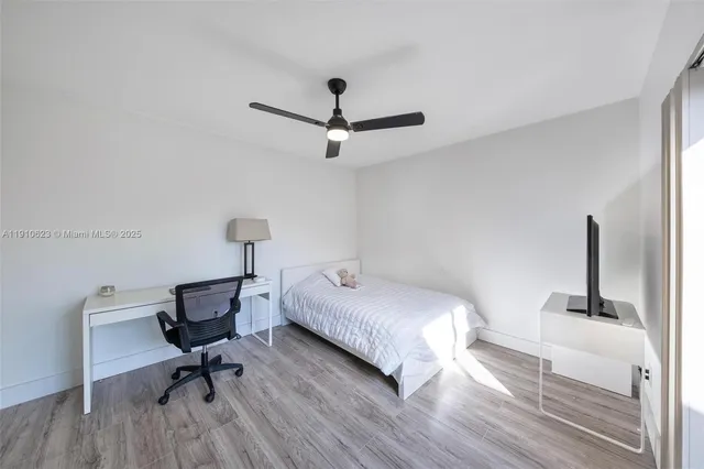 a bedroom with a bed a desk and chair