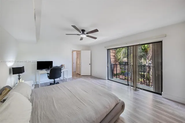 a bed room with a bed and a large window