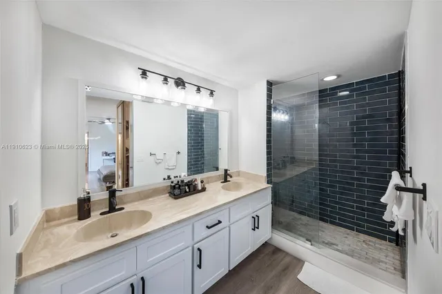 a bathroom with a double vanity sink and mirror
