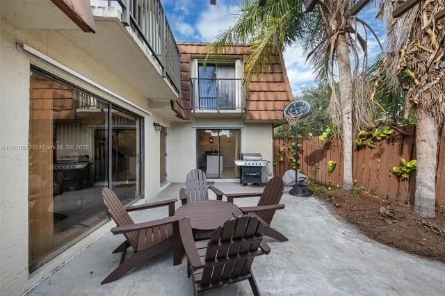 a view of a patio with table and chairs and potted plants