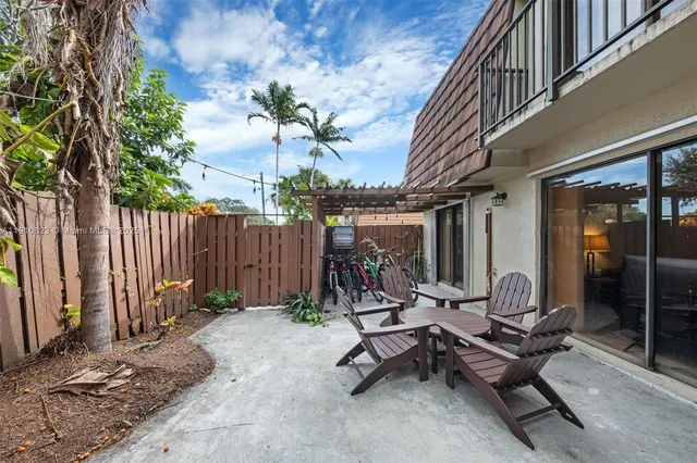 a view of a backyard with a patio and outdoor seating
