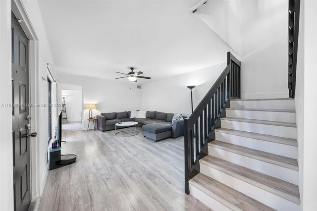 a living room with furniture and a wooden floor