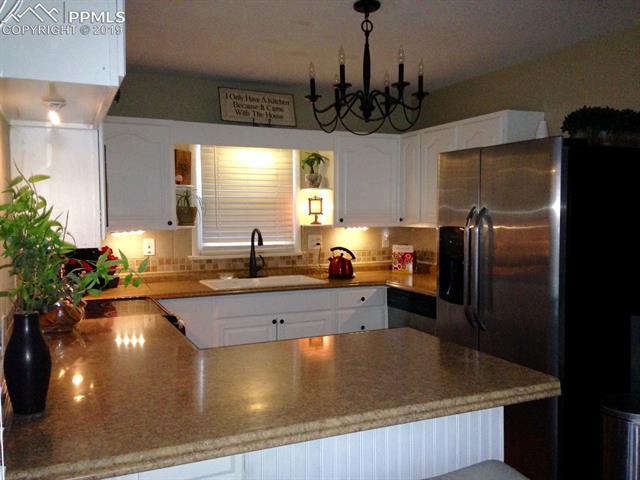 522 Valley Road Colorado Springs, CO 80904 - Photo 7 of 26 Stainless steel appliances and new cast iron sink.