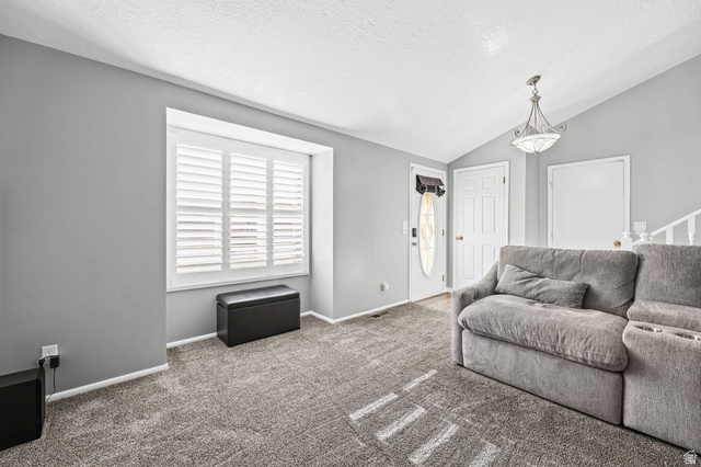 5896 South 3950th Street West Roy, UT 84067 - Photo 4 of 29 Living area featuring baseboards and carpet flooring