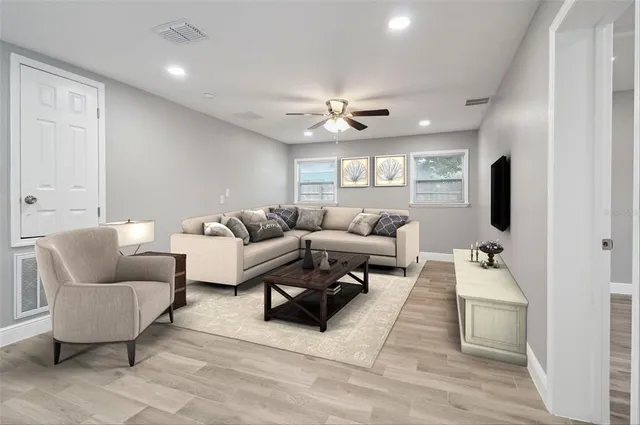 a living room with furniture and a chandelier