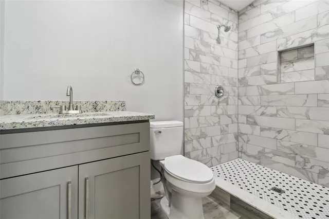 a bathroom with a sink toilet and shower