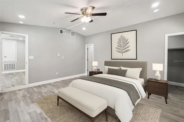 a bedroom with a bed and a chandelier