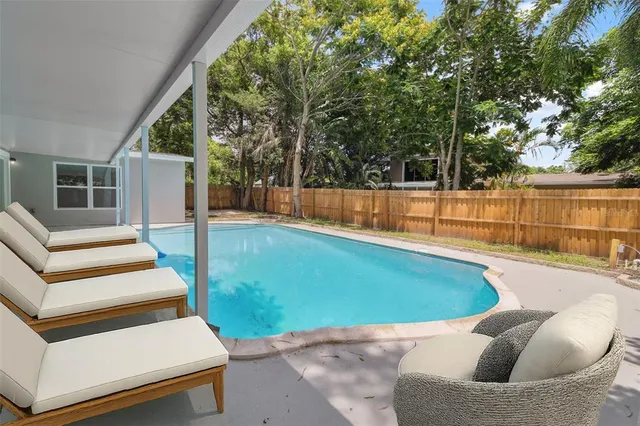 a view of swimming pool with seating space
