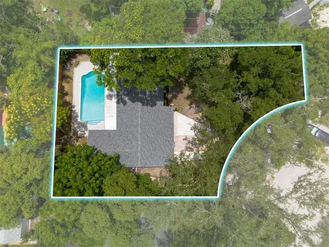 an aerial view of a house with a yard