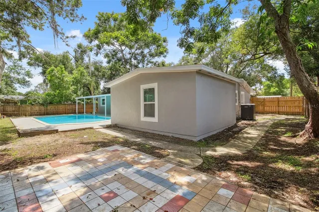 a view of backyard of house with trees