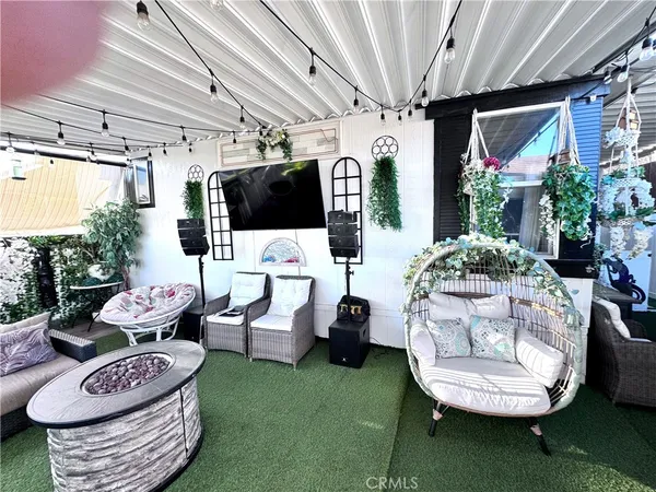 a view of a chairs and table in backyard