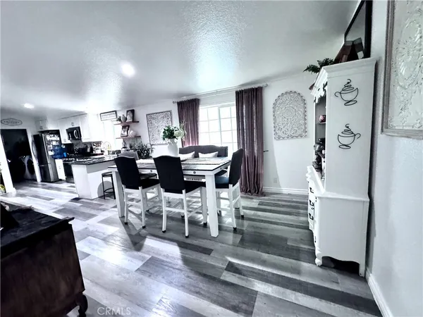 a kitchen with stainless steel appliances granite countertop a stove a sink dishwasher and cabinets with wooden floor