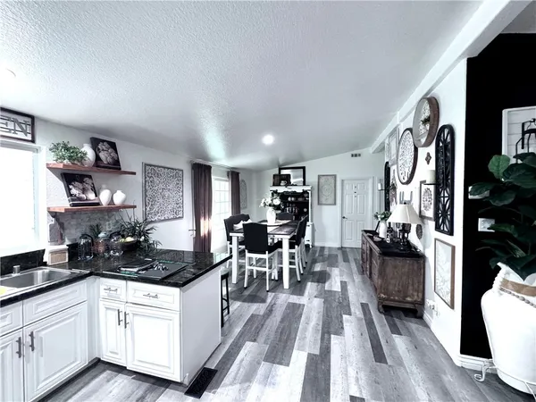 a bedroom with a bed and a view of kitchen
