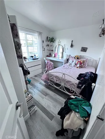 a bedroom with bed and a window