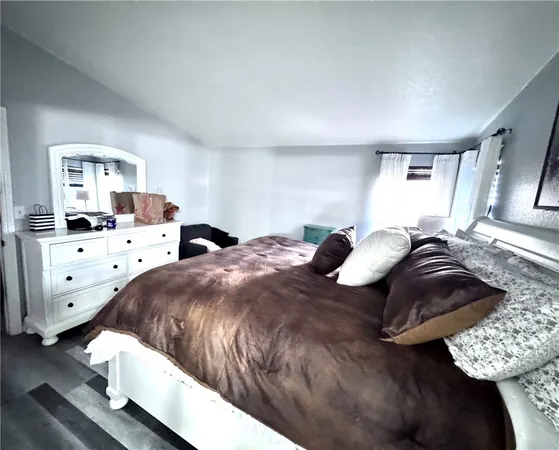 a bathroom with a toilet and a painting on the wall