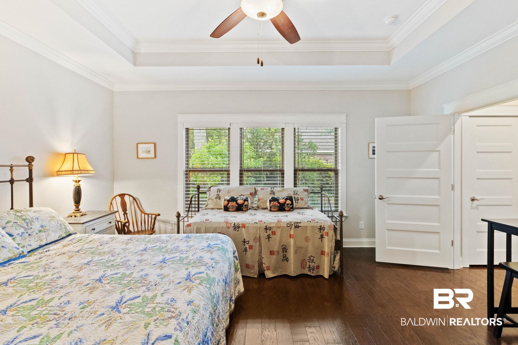 192 Mark Twain Loop Foley, AL 36535 - Photo 21 of 42 Bedroom with crown molding, ceiling fan, a raised ceiling, and dark wood-type flooring