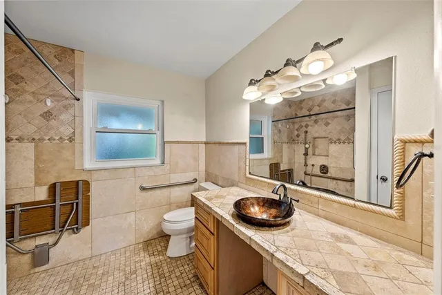 a bathroom with a sink a light fixture and a mirror
