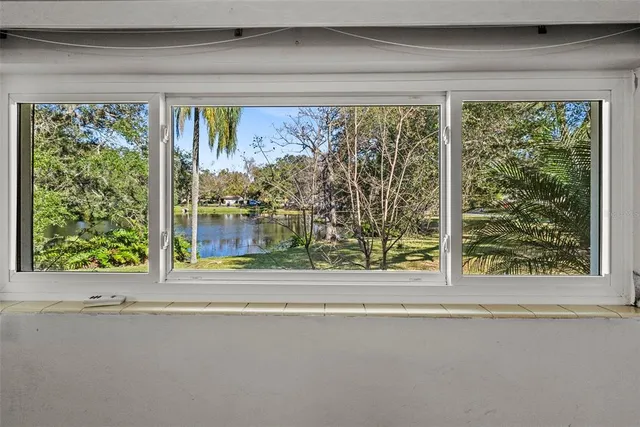 a view of a room that has a bed and a window