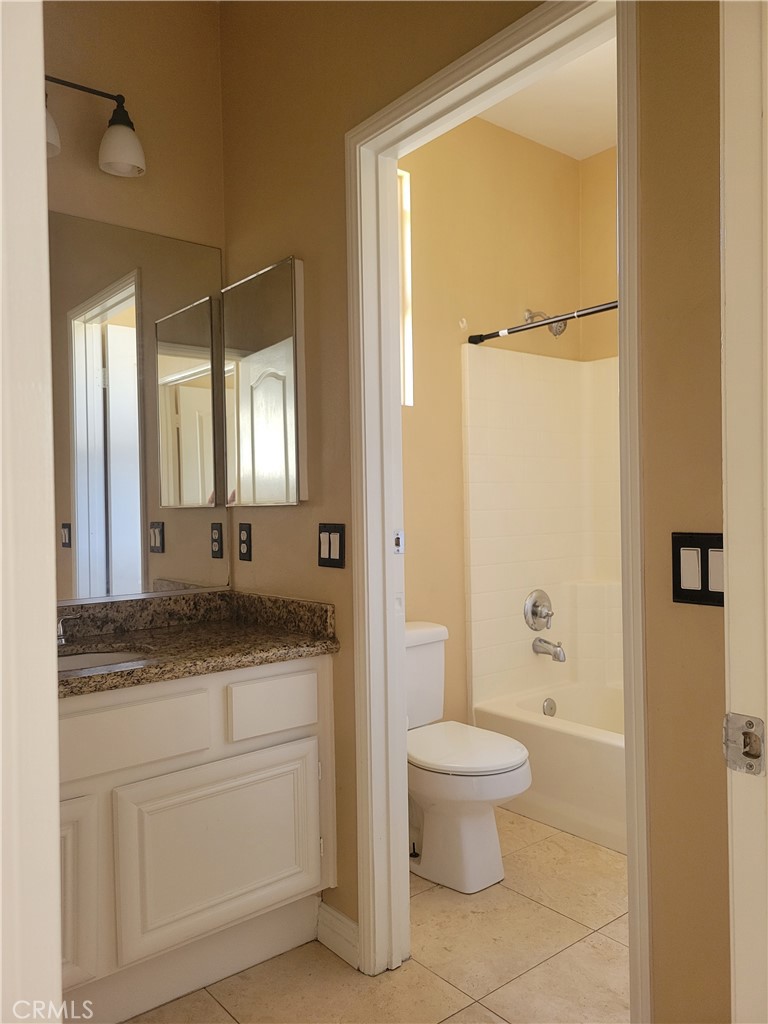 28 First Street Ladera Ranch, CA 92694 - Photo 14 of 18 a bathroom with a granite countertop sink toilet and shower