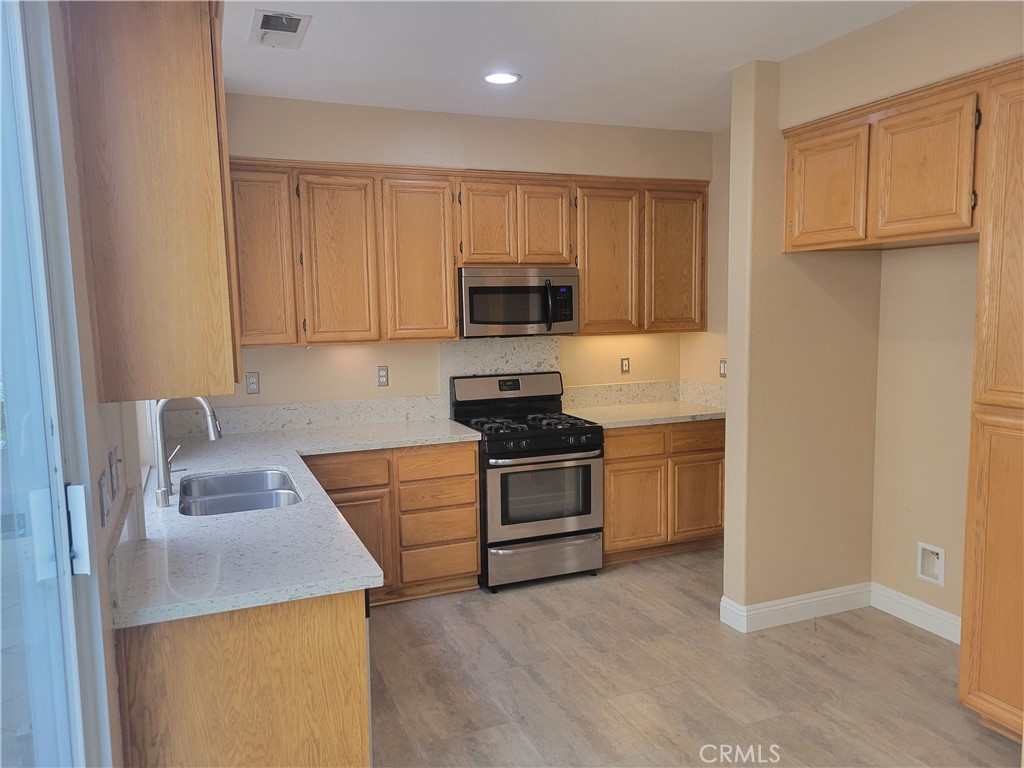 28 First Street Ladera Ranch, CA 92694 - Photo 8 of 18 a kitchen with a sink and a stove top oven