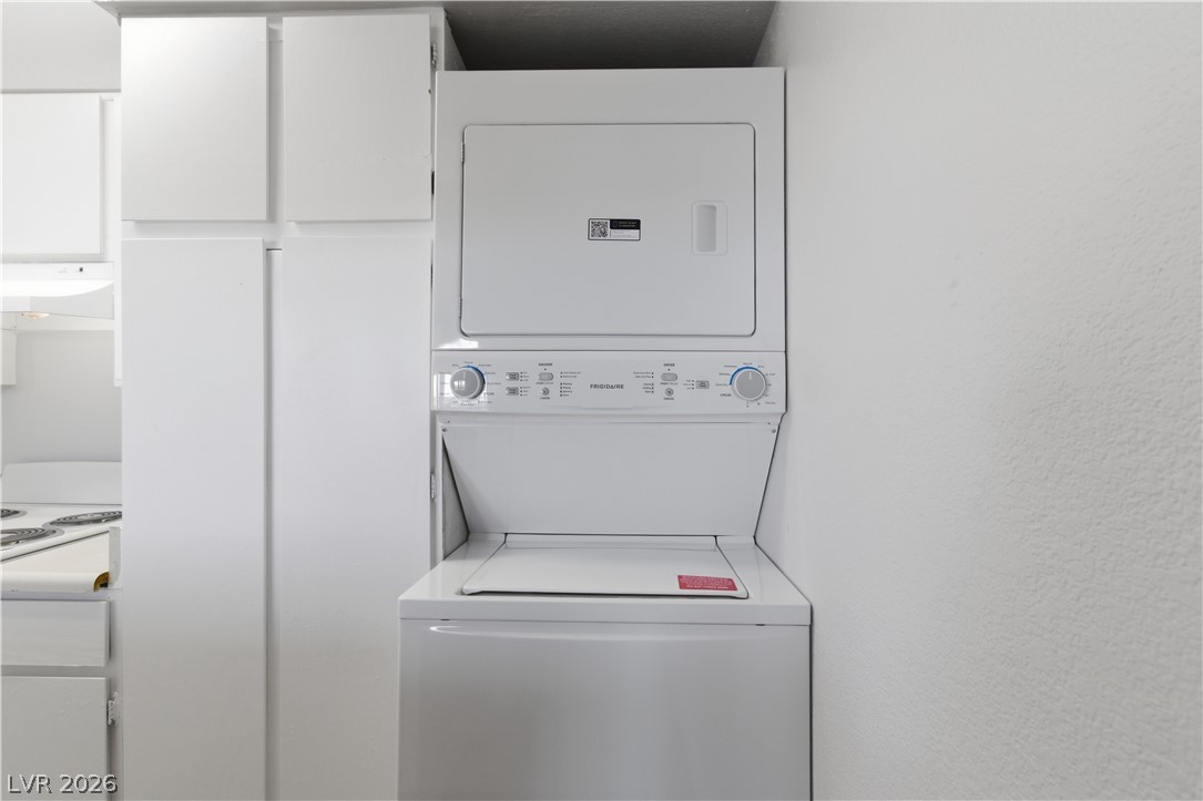 2221 West Bonanza Road, Unit 28 Las Vegas, NV 89106 - Photo 13 of 15 This compact laundry area features stacked appliances, offering efficiency and convenience.