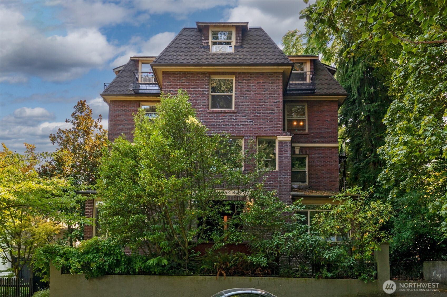 1425 East Prospect Street, Unit 110 Seattle, WA 98112 - Photo 1 of 40 a front view of a house with a yard