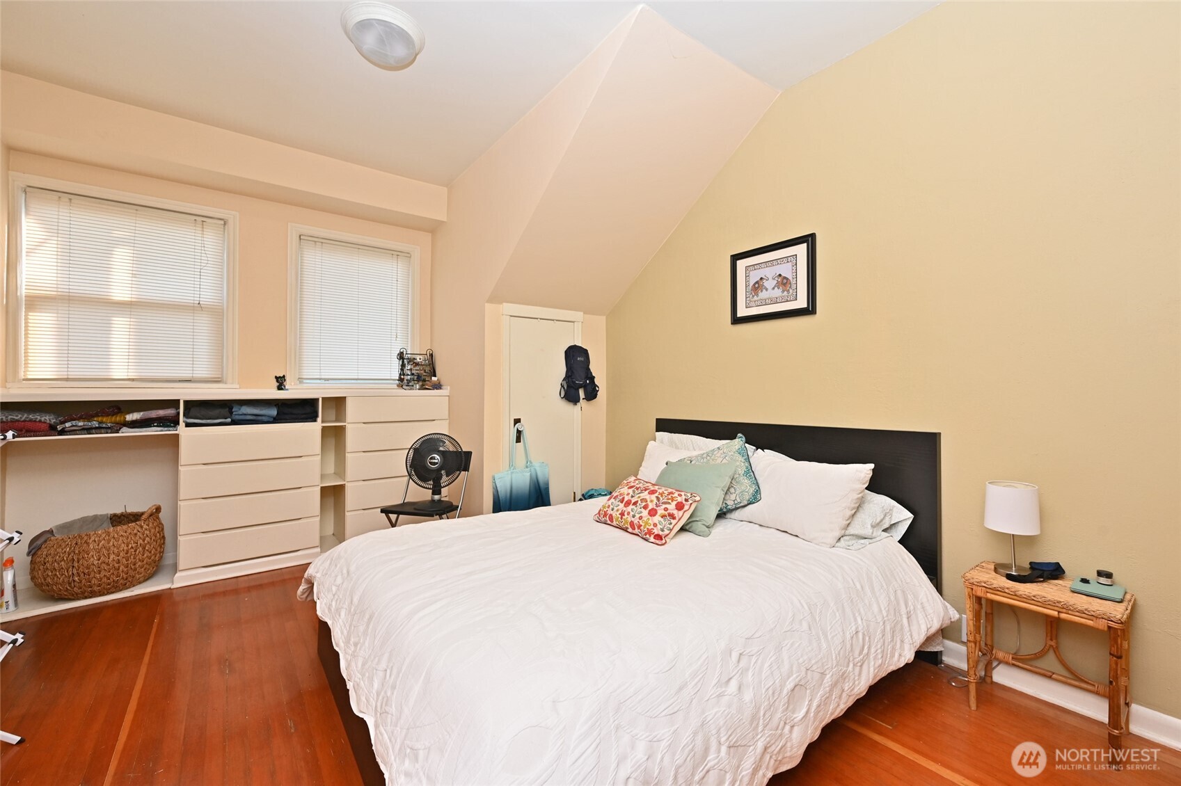 1425 East Prospect Street, Unit 110 Seattle, WA 98112 - Photo 13 of 40 a bedroom with a bed and wooden floor