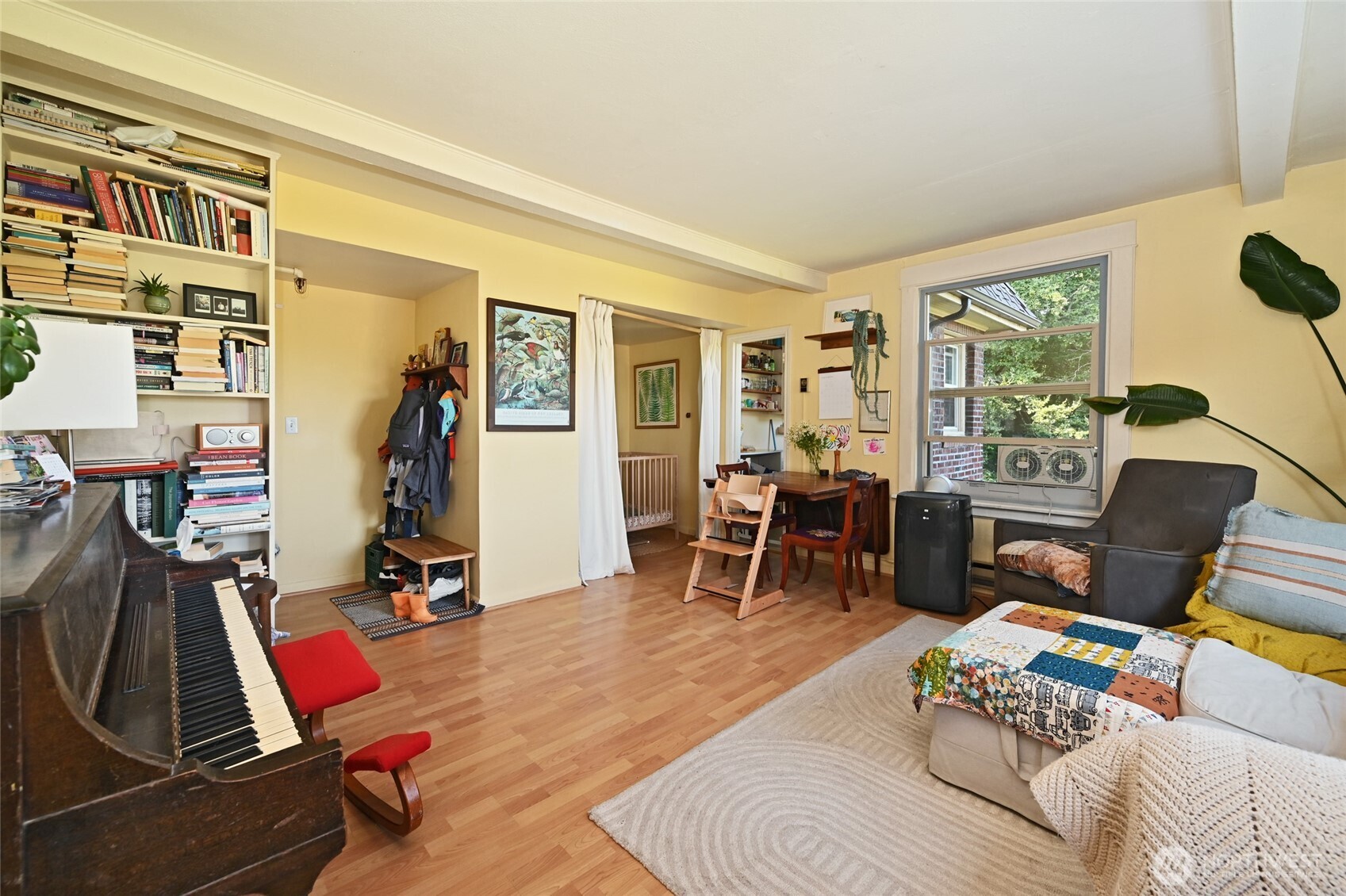 1425 East Prospect Street, Unit 110 Seattle, WA 98112 - Photo 16 of 40 a living room with furniture a flat screen tv and floor to ceiling windows