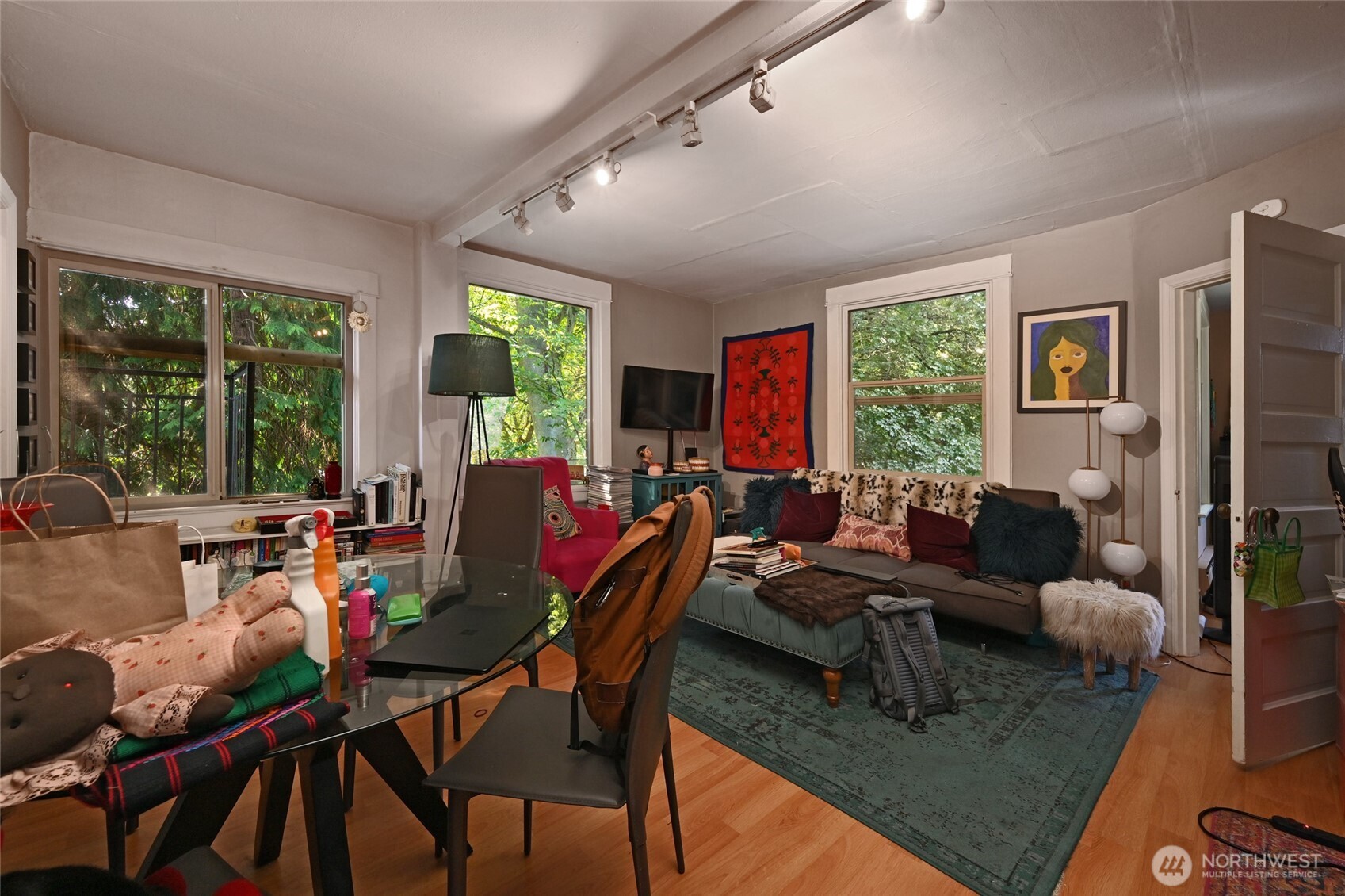 1425 East Prospect Street, Unit 110 Seattle, WA 98112 - Photo 21 of 40 a living room with furniture floor to ceiling window and a flat screen tv